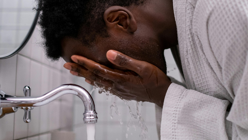 man washing his face 